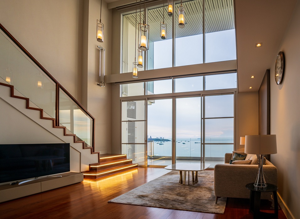 A picture of a luxurious home interior, the camera is facing to the balcony with sea view to Pattaya Bay. Photo by Sean Witt RE/MAX Capital Property Real Estate Consultant.